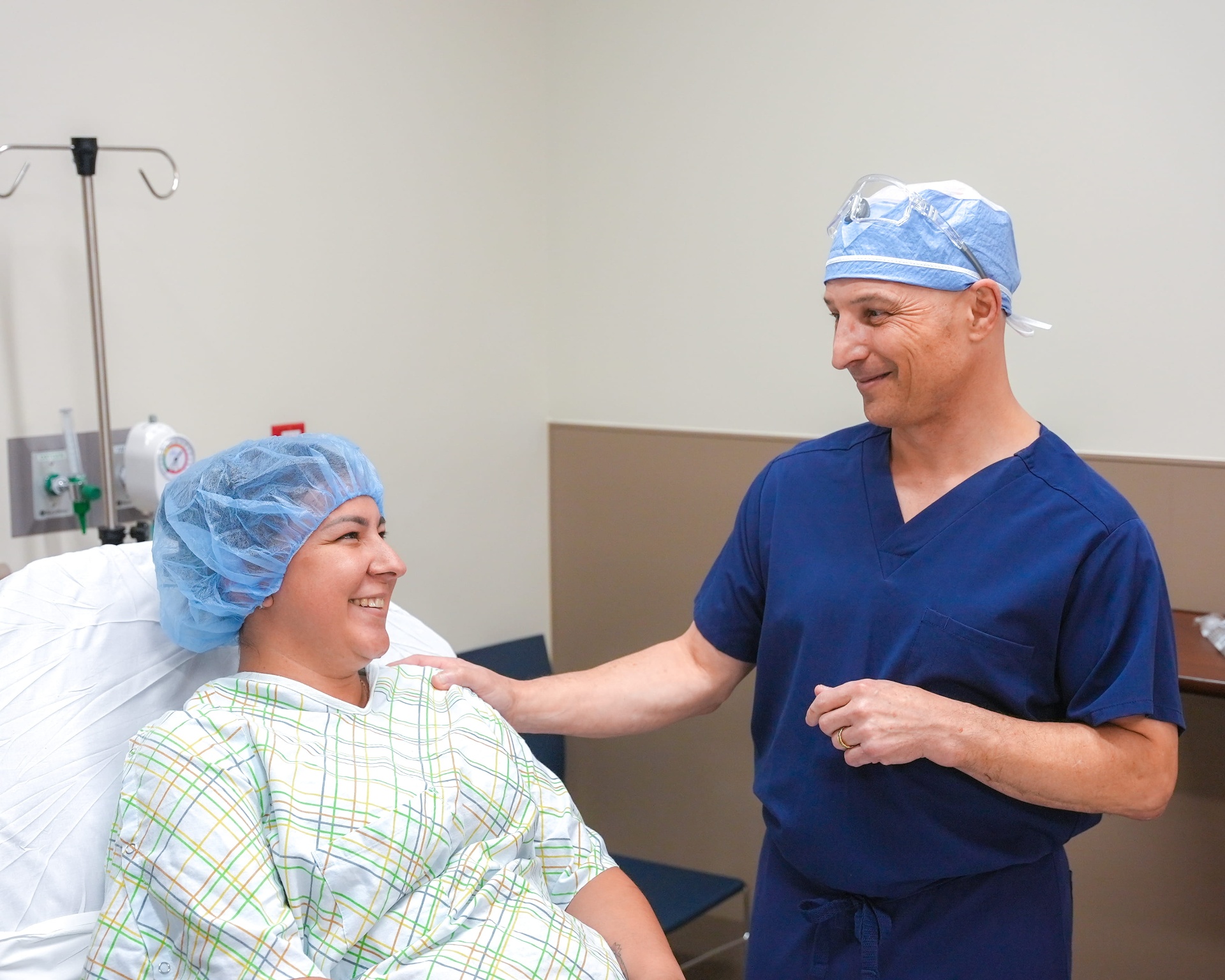 A surgeon comforting a patient before her procedure at ABQ Surgery Center